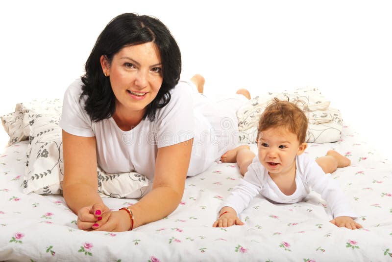 Happy mom and baby laying in bed