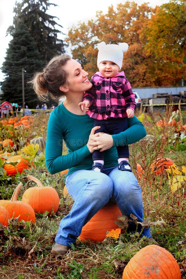 Happy Mom and Baby in pumpkin patch royalty free stock images Happy Mom and Baby in pumpkin patch royalty free stock images