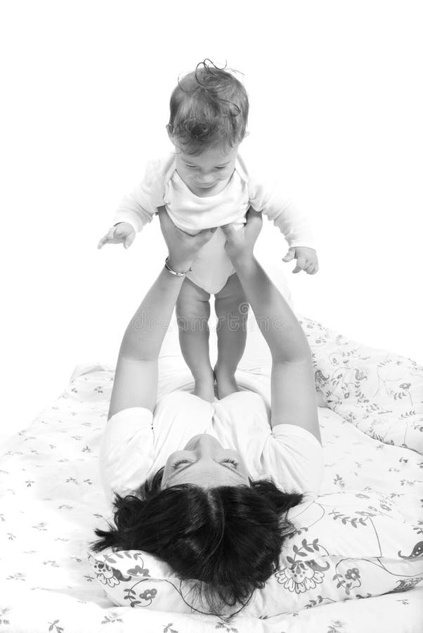 Happy mom and baby in white clothes