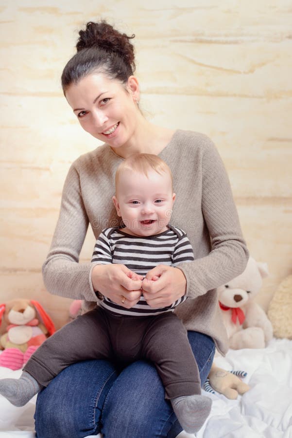 Happy Mom and her Baby Smiling at the Camera stock photos Happy Mom and her Baby Smiling at the Camera stock photos