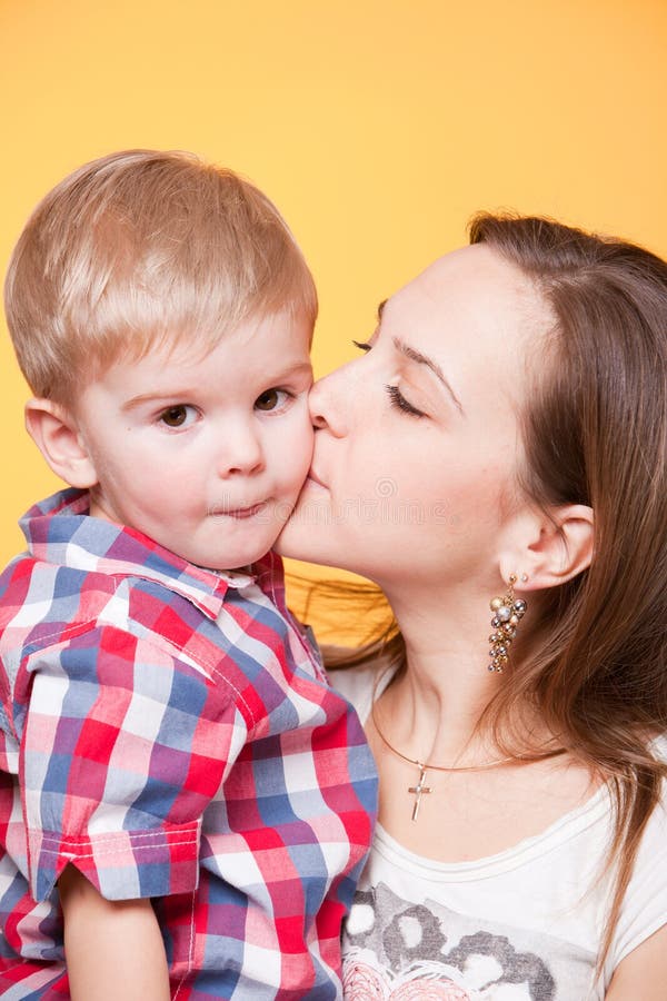 Happy mom kissing little son