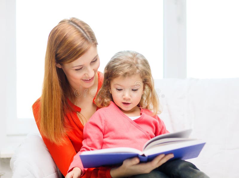 Happy mother and daughter with book stock photo