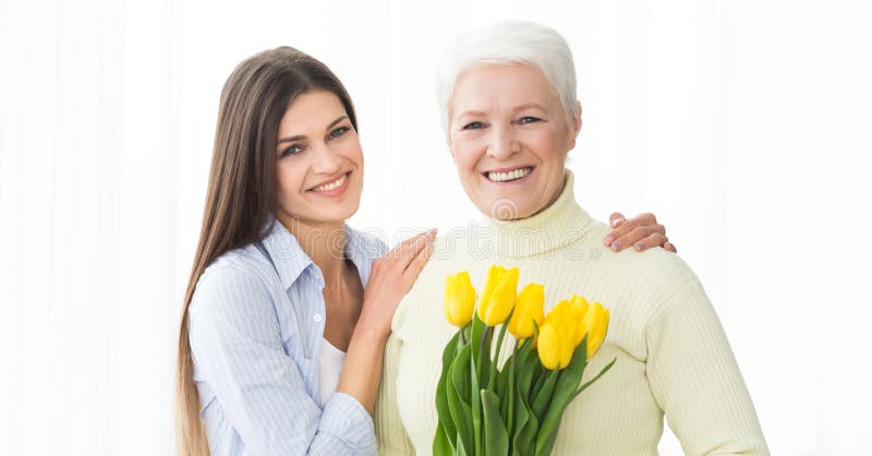 Happy mother and daughter with bouquet of tulips royalty free stock photo Happy mother and daughter with bouquet of tulips royalty free stock photo