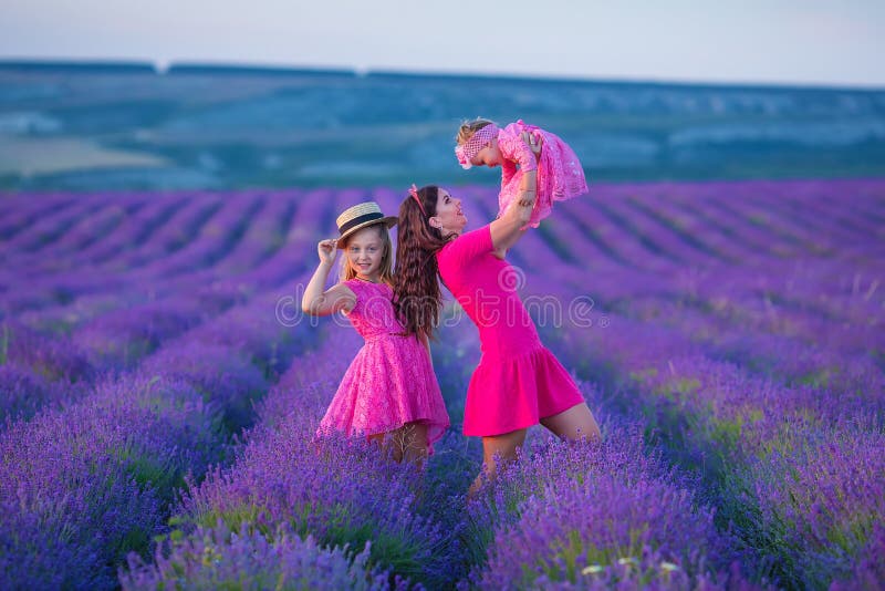 Happy mother and daughter child together with yellow dandelion flowers in summer day enjoy vacation free time together happy