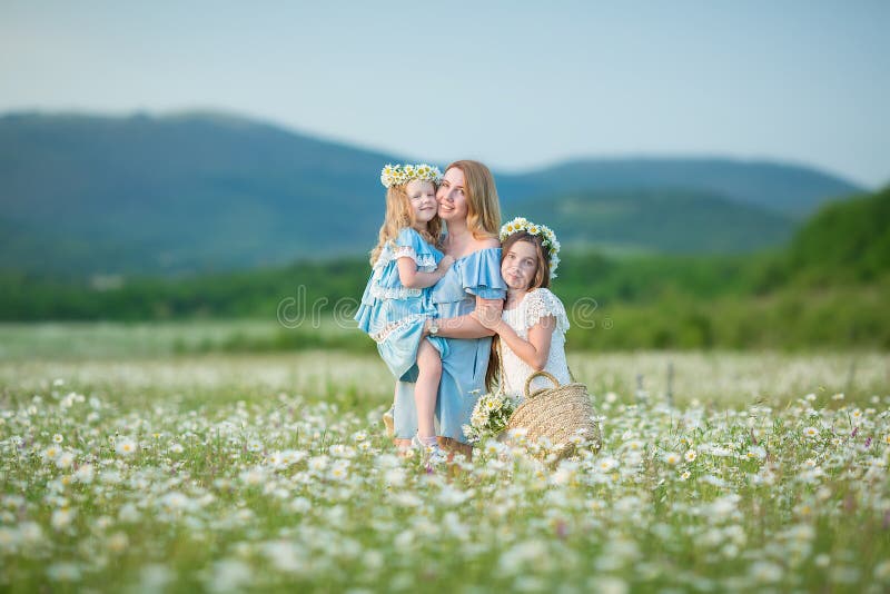 Happy mother and daughter child together with yellow dandelion flowers in summer day enjoy vacation free time together happy