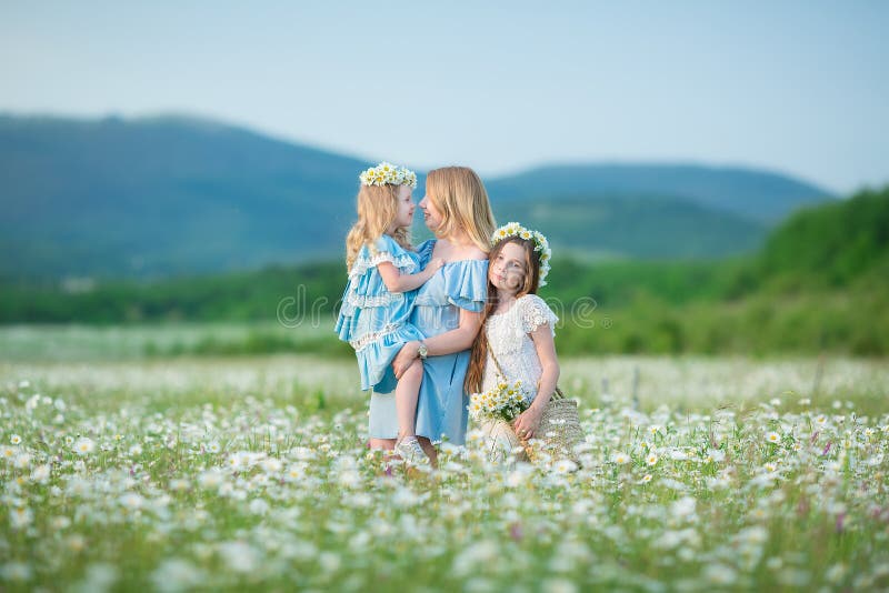 Happy mother and daughter child together with yellow dandelion flowers in summer day enjoy vacation free time together happy