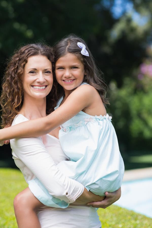 Happy Mother and Daughter Hugging Stock Image - Image of garden