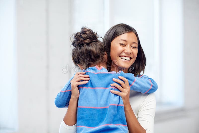 Family, children, love and happy people concept - happy mother and daughter hugging at home