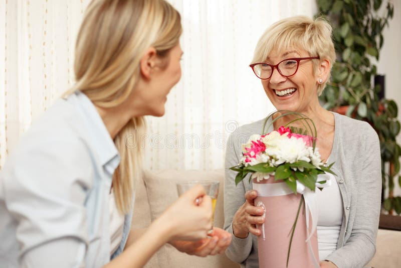 Mother and daughter enjoying conversation in living room stock photos Mother and daughter enjoying conversation in living room stock photos