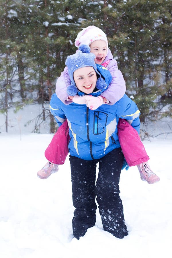 Happy mother and daughter in a winter park