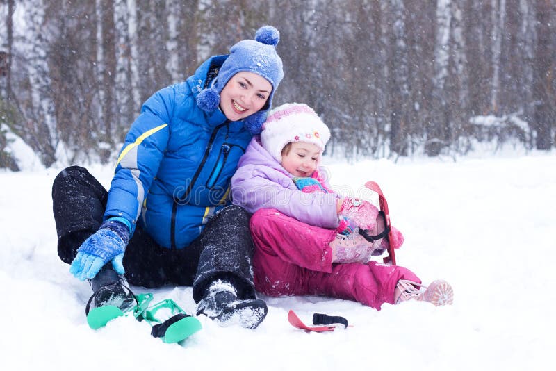 Happy mother and daughter in a winter park