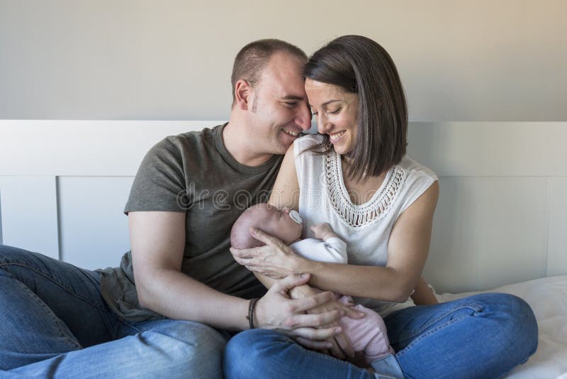 happy mother and father with her baby girl at home. Lifestyle indoors and family love concept royalty free stock image happy mother and father with her baby girl at home. Lifestyle indoors and family love concept royalty free stock image