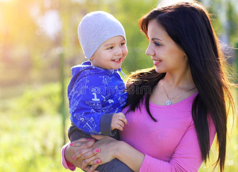 Happy Mother and her Child enjoy the early Spring in Park