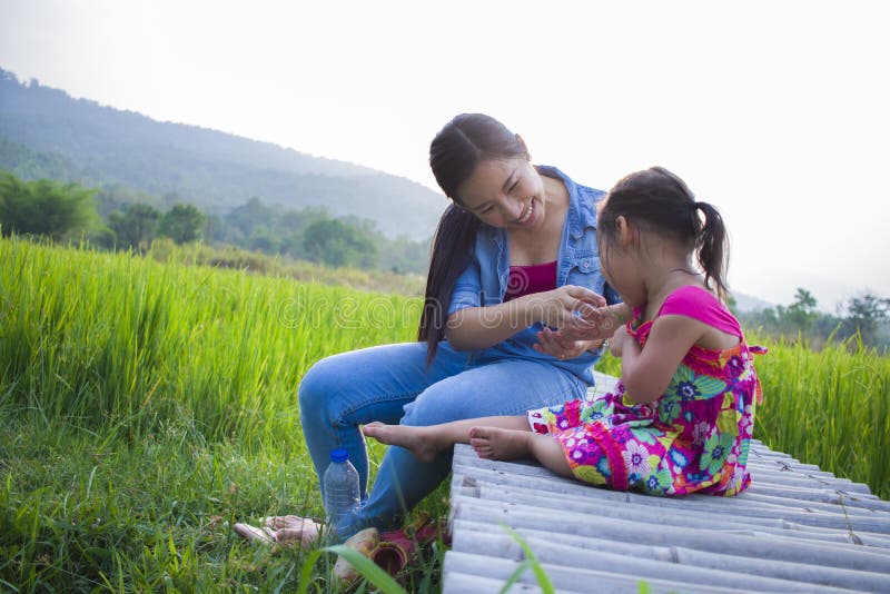 Happy Mother and her child play outdoors having fun, Green rice field back ground royalty free stock photos Happy Mother and her child play outdoors having fun, Green rice field back ground royalty free stock photos