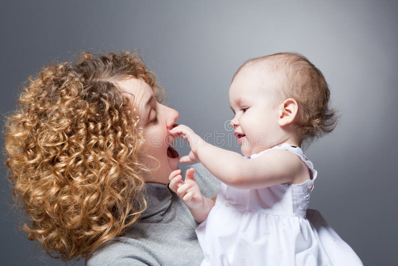 Happy mother holding cute smiling baby