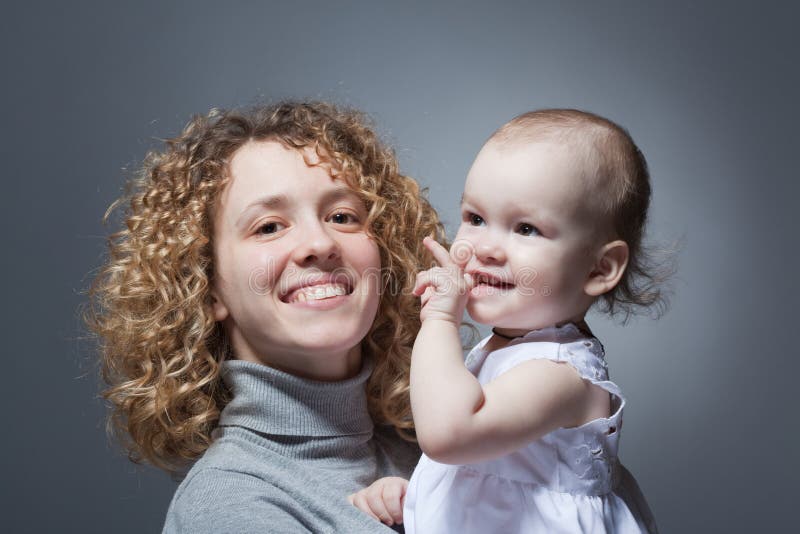 Happy mother holding cute smiling baby