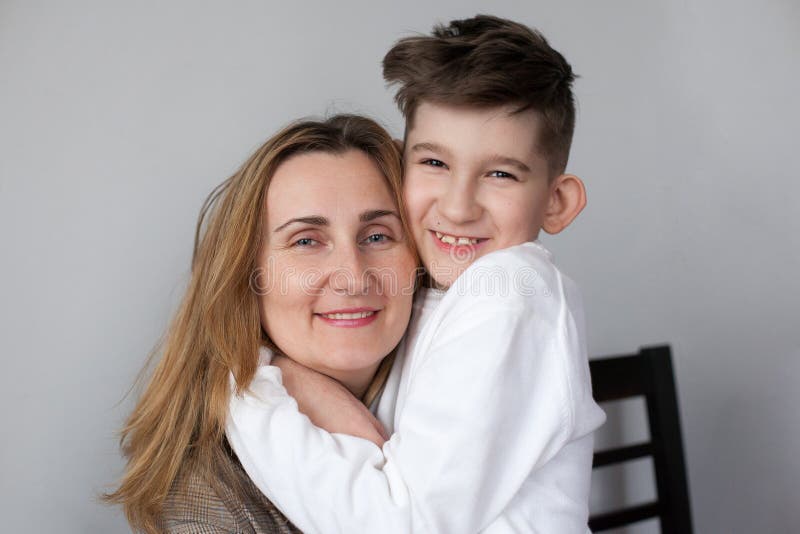 Happy mother hugging her son at home royalty free stock photography