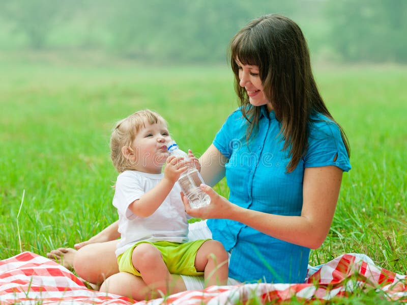 Happy Mother and Kid Drinking Water from Bottle Stock Image - Image of