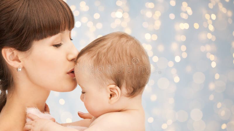 Happy mother kissing adorable baby