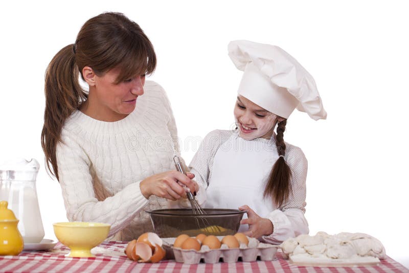 Happy mother with little daughter joyful cooking