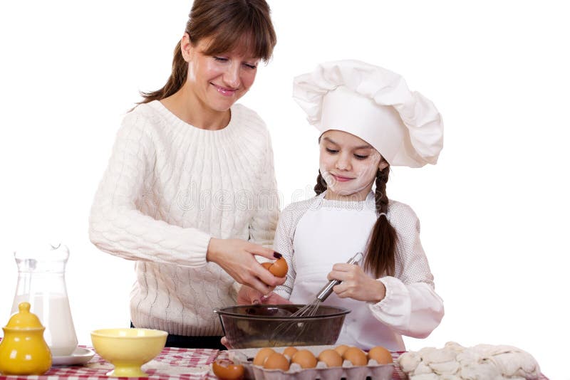 Happy mother with little daughter joyful cooking