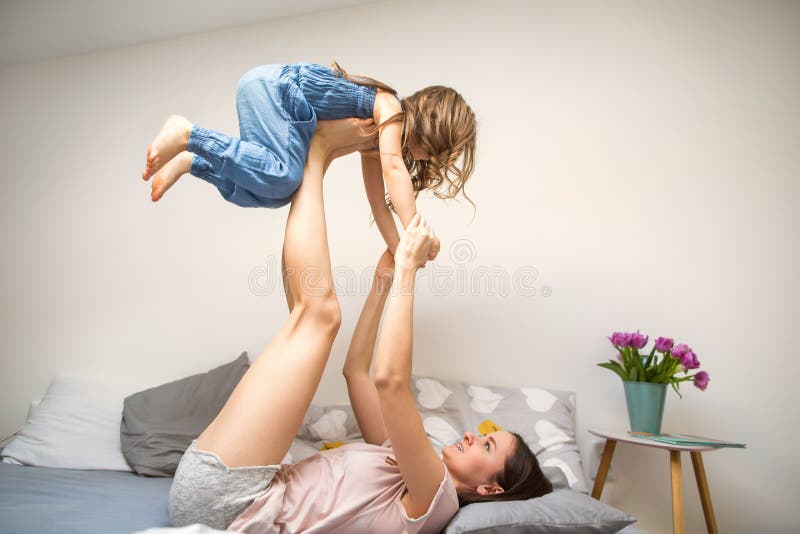 Happy mother playing with her daughter at home, mother`s day