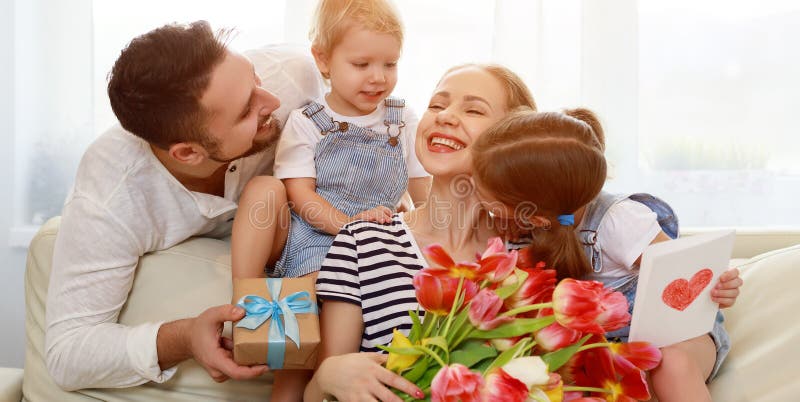 Happy mother`s day! father and children congratulate mother on h stock photo Happy mother`s day! father and children congratulate mother on h stock photo