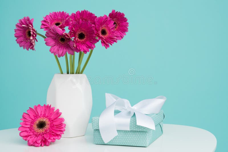 Dark pink gerberas in a vase on a retro table. Happy Mother`s Day, Women`s Day, Valentine`s Day or Birthday background. royalty free stock image Dark pink gerberas in a vase on a retro table. Happy Mother`s Day, Women`s Day, Valentine`s Day or Birthday background. royalty free stock image