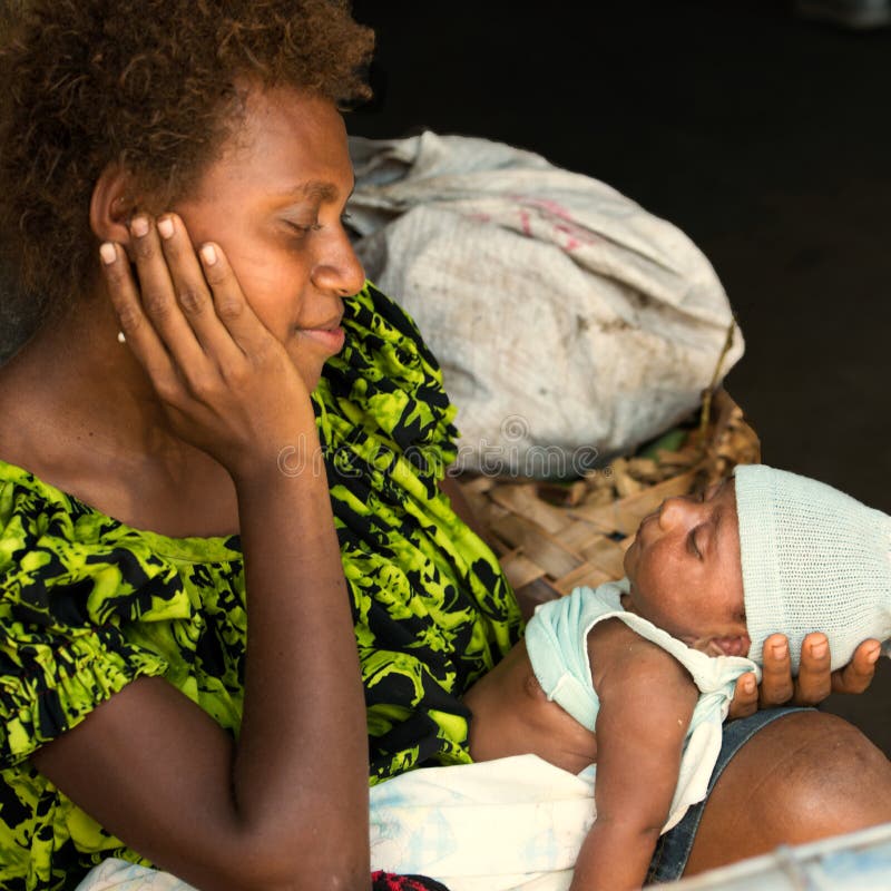 Happy mother with newborn baby. Mum looking gladly to newborn child, Rabaul, Papua New Guinea