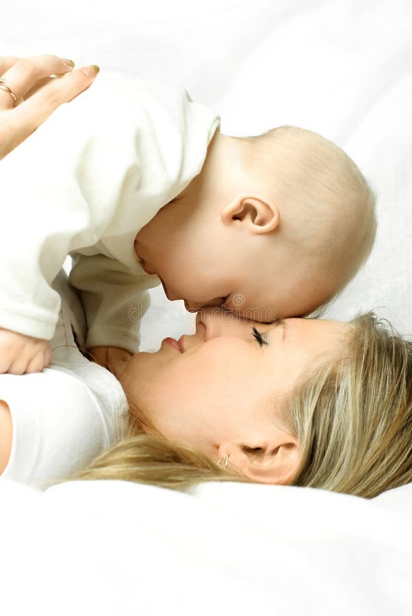 Happy mother on the sofa with her baby