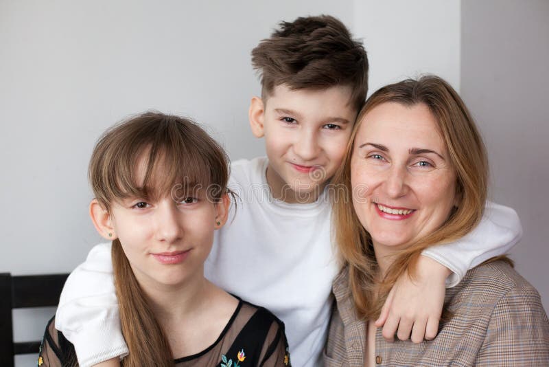 Happy mother with two children at home stock image