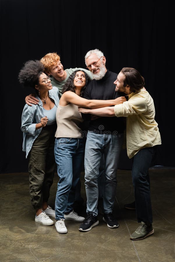 Happy multicultural students hugging acting skills stock photos