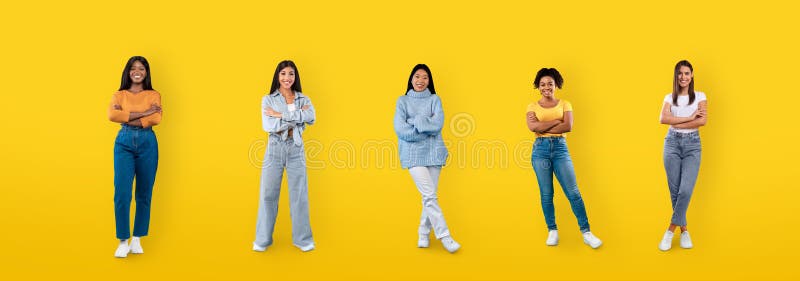 Happy multiethnic millennial ladies posing on yellow background, web-banner stock images