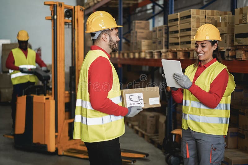 Happy multiracial workers talking inside warehouse store - Focus on woman face royalty free stock photos