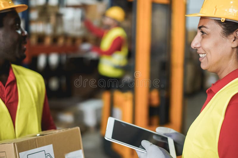 Happy multiracial workers talking inside warehouse store - Focus on woman face stock image
