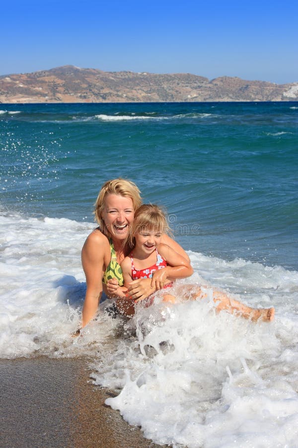 Happy mum with daughter have rest on the sea