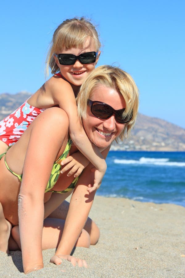 Happy mum with a daughter have a rest on the sea