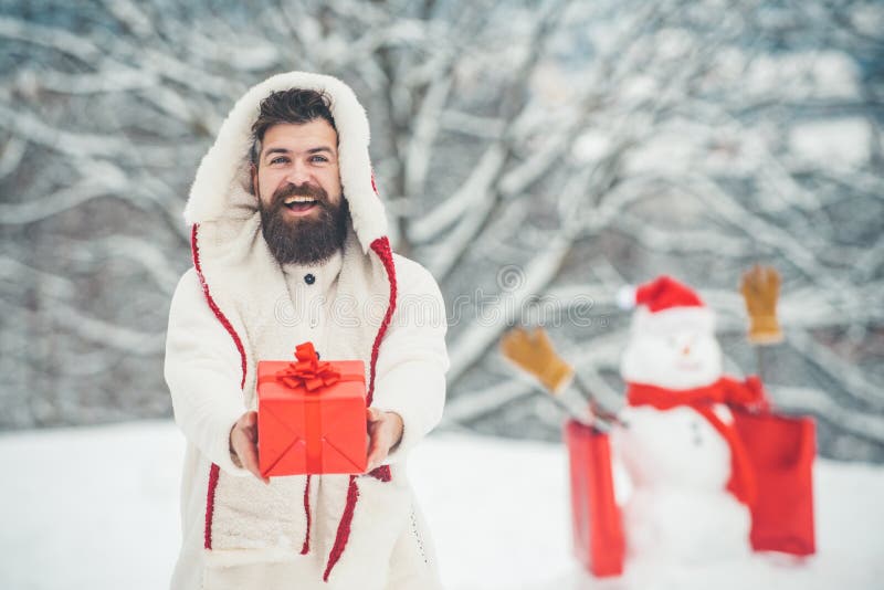 Happy new year. Happy father playing with a snowman on a snowy winter walk. Santa Claus wishes Merry Christmas. royalty free stock photos Happy new year. Happy father playing with a snowman on a snowy winter walk. Santa Claus wishes Merry Christmas. royalty free stock photos