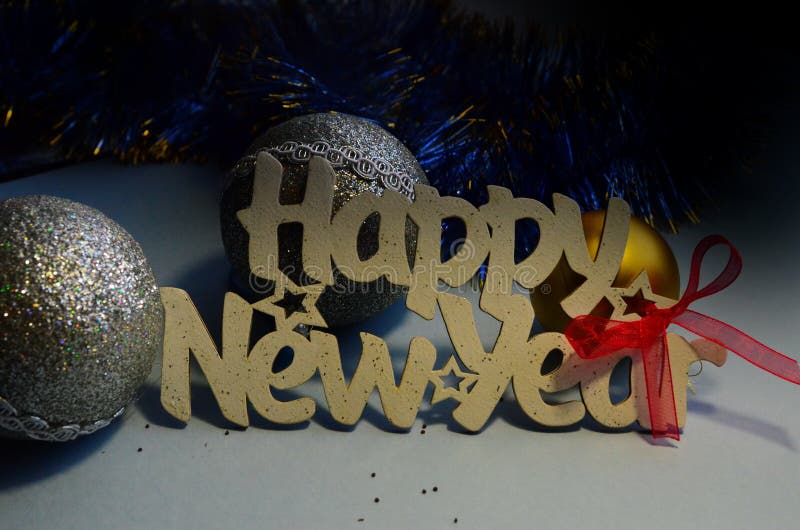 Happy New Year - white wood text in vintage style on a color background close up. Happy New Year - white wood text in vintage style on a color background close up