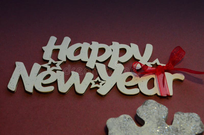 Happy New Year - white wood text in vintage style on a color background close up. Happy New Year - white wood text in vintage style on a color background close up