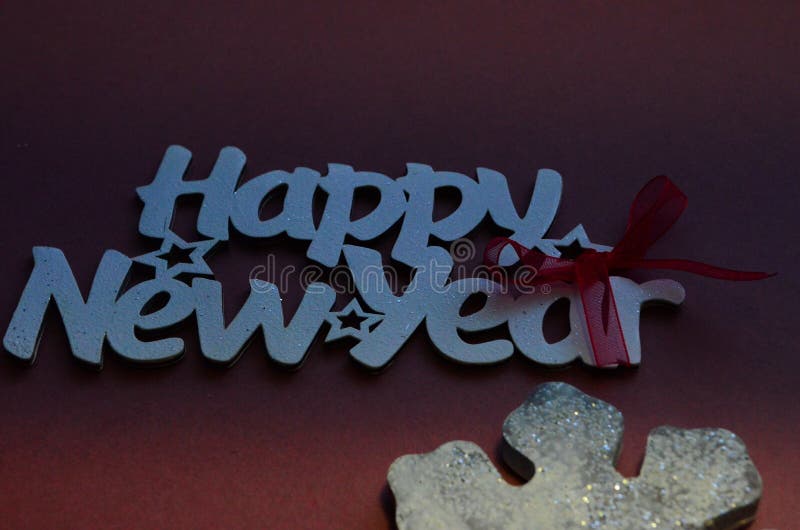 Happy New Year - white wood text in vintage style on a color background close up. Happy New Year - white wood text in vintage style on a color background close up