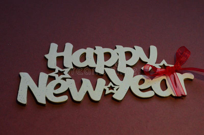 Happy New Year - white wood text in vintage style on a color background close up. Happy New Year - white wood text in vintage style on a color background close up