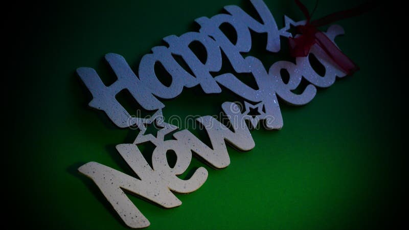 Happy New Year - white wood text in vintage style on a color background close up. Happy New Year - white wood text in vintage style on a color background close up