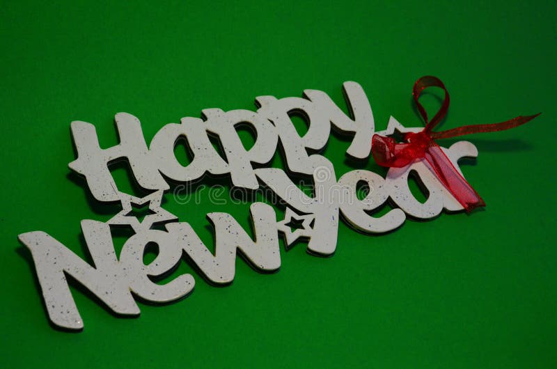 Happy New Year - white wood text in vintage style on a color background close up. Happy New Year - white wood text in vintage style on a color background close up