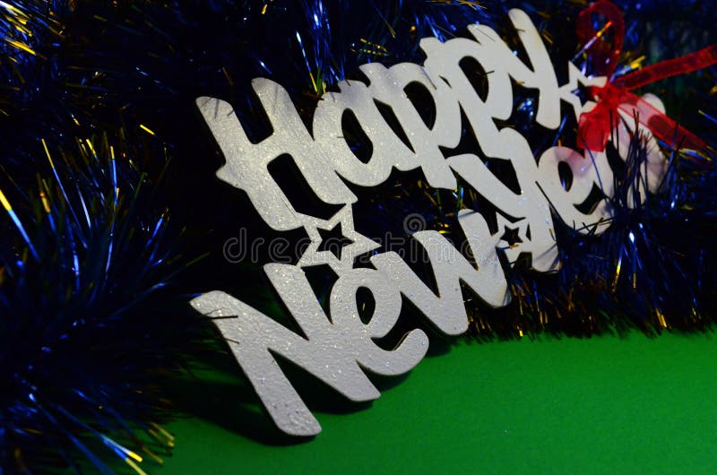 Happy New Year - white wood text in vintage style on a color background close up. Happy New Year - white wood text in vintage style on a color background close up