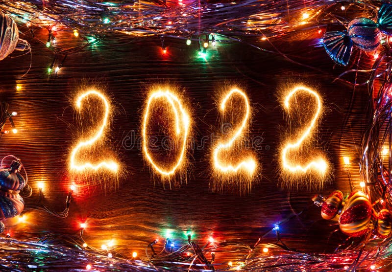 Happy New Year 2022 with lights and decoration on wood background.  stock image