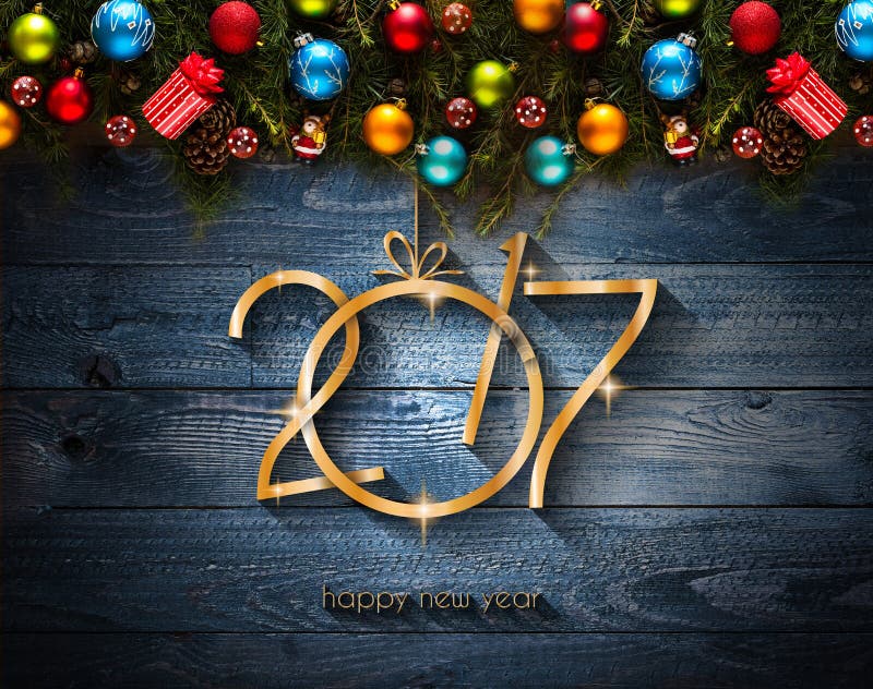2017 Happy New Year seasonal background with Christmas baubles. 2017 Happy New Year seasonal background with real wood green pine, colorful Christmas baubles royalty free stock images