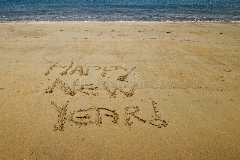 Happy New Year written in the golden sand of Little Kaiteriteri beach royalty free stock photo Happy New Year written in the golden sand of Little Kaiteriteri beach royalty free stock photo