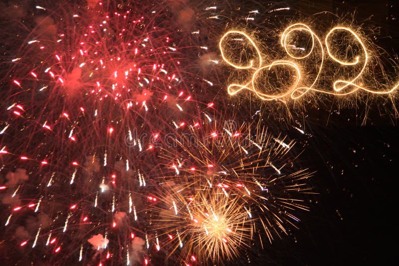 Happy New Year 2022. Written with Sparklers against Fireworks background stock images Happy New Year 2022. Written with Sparklers against Fireworks background stock images