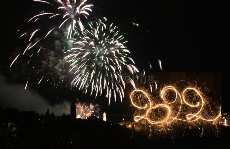 Happy New Year 2022. Written with Sparklers against Fireworks background stock photos